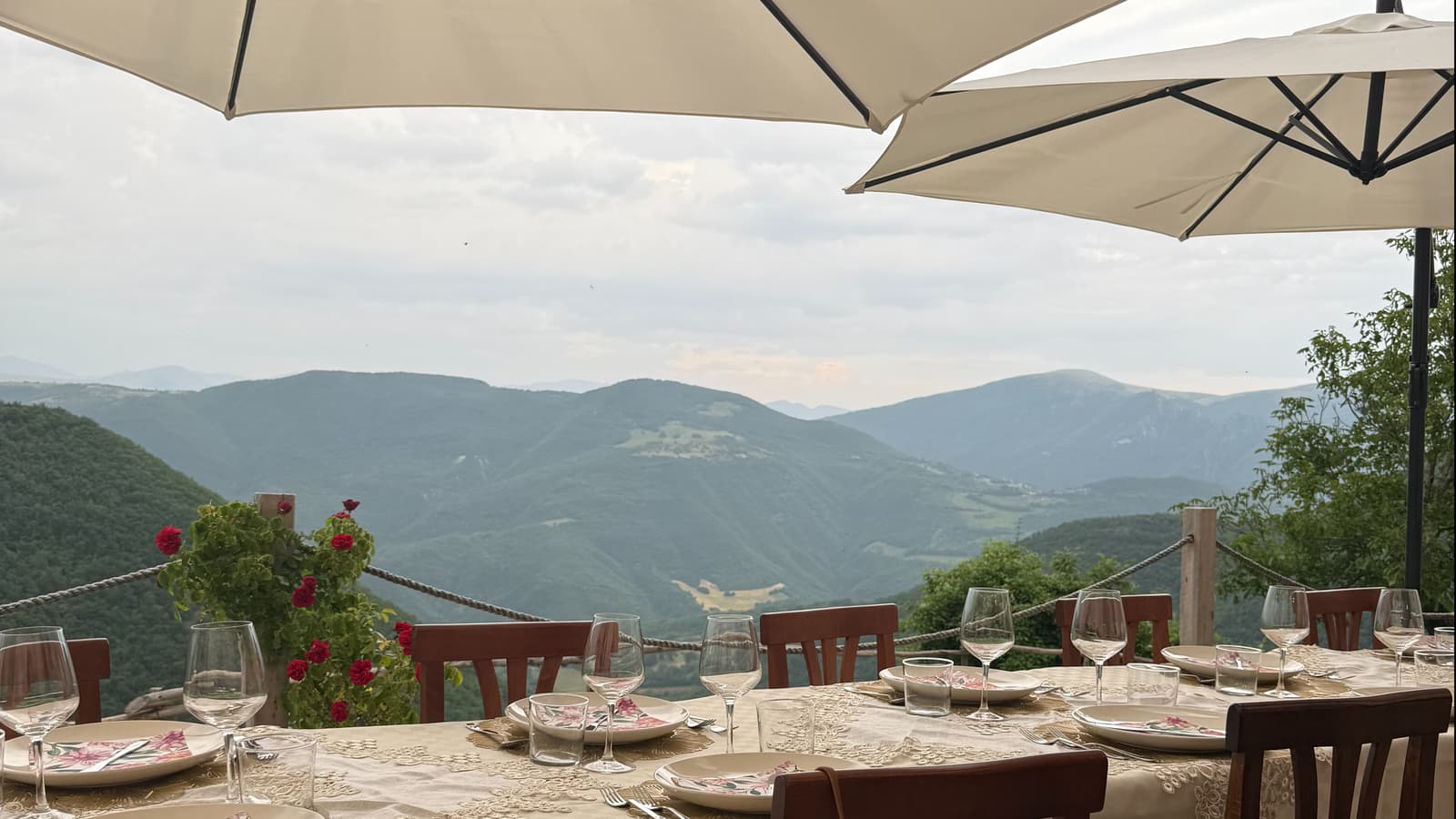 Travelers rescuing lunch from the rain in a countryside garden in Umbria