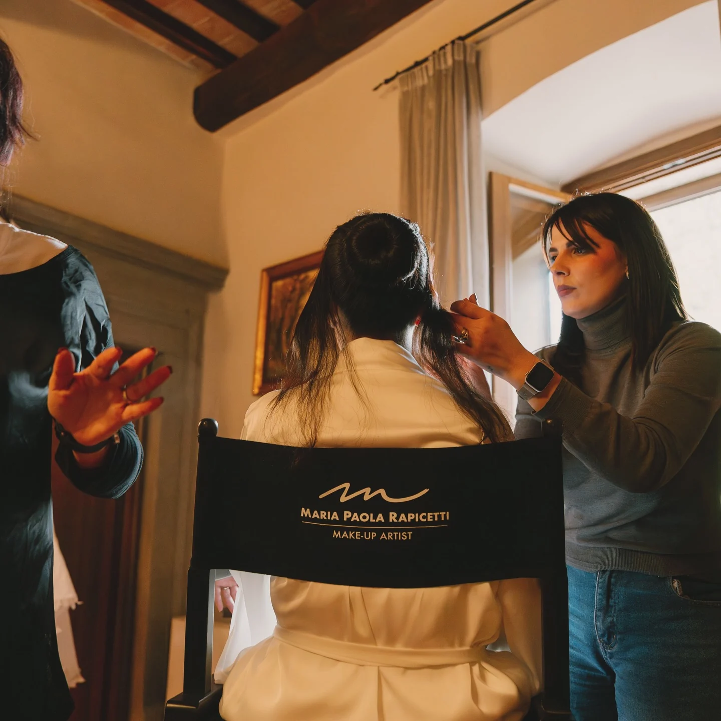 Makeup artist preparing bride